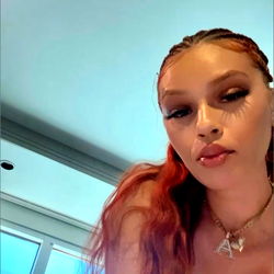 Angela, a Californian OnlyFans model with striking red hair and an edgy style.