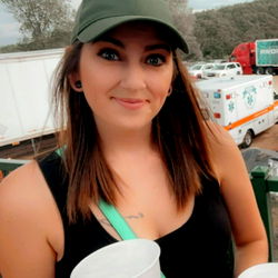 Bre Michelle: A Young Woman Posing Outdoors with Drinks