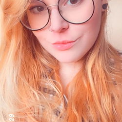 Miss Aurora, a Stylish Lady with Blonde Hair and Blue Glasses