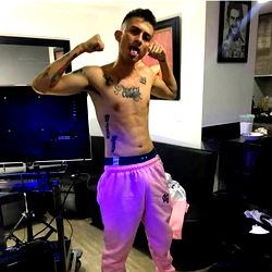 OnlyFans model Alejo Cobhit poses shirtless in pink sweatpants