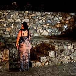 Woman in a dress at night on a stone patio