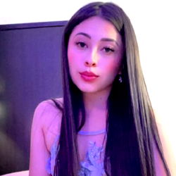 Long-haired beauty in a vibrant purple dress, exuding confidence with a red lipstick touch.