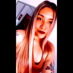 Agostina, a beautiful young woman with long blonde hair and tattoos.