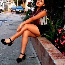 Young Woman Sitting on a Ledge