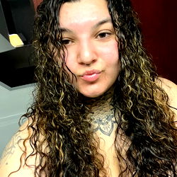 Alyssa R. Showcasing Her Long Curly Hair