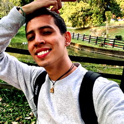 Angel Barrios posing for a selfie outdoors