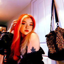 Engaging OnlyFans Model Posing Against Wall with Handbag and Purse