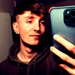 Adam, A Young Male with Short Hair and Tattoos on His Arms