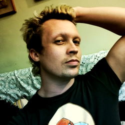 Young Adult Male with Tattoo and Short Hair