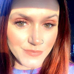 Haylee in a casual pose with red hair and sunglasses