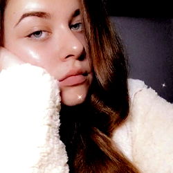 Evie, a young adult female, in casual attire with a serene expression.