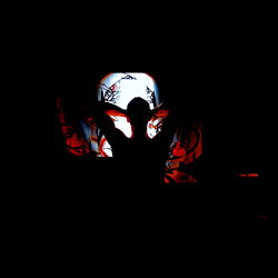 Silhouette of a Person Against a Lighted Screen