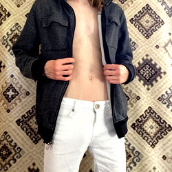 Model with Exposed Midriff in White Jeans and Black Jacket,