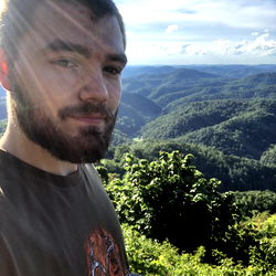 Austin Jack Jackson in a scenic mountainous area, possibly on vacation or a hike.