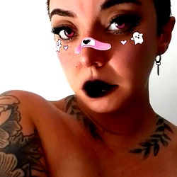 LilBaddie - Stylish Tattooed Model in Playful Pose