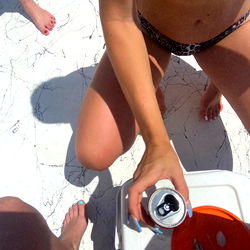 Bikini-Clad Woman Enjoying a Beer at the Beach