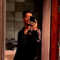 Professional Model Andrew Adams Captures Confident Selfie in Bathroom Mirror
