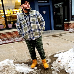 Angelo Rodriguez, a local artist posing in an urban environment
