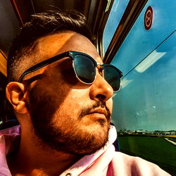 A Bearded Man Sitting on a Train