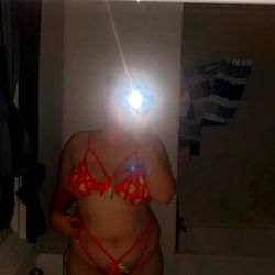 Sneaky Selfie of a Woman in a Bathroom Mirror