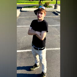 A Young Man Standing Outdoors