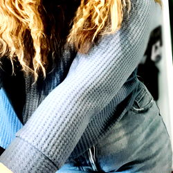 Sarah, a young adult from Canada, showcases her style with a casual, comfortable look in this image.