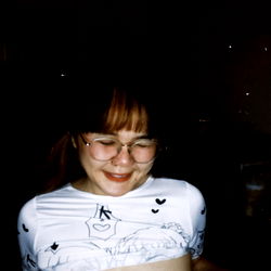 A young woman in a graphic top posing for the camera