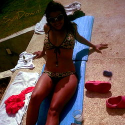 Female Onlyfans Model Reclining on Pool Deck