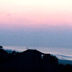 Serene Beach Sunset with City Skyline