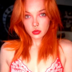 Ash Inferno: Red-haired OnlyFans model in bold red lipstick
