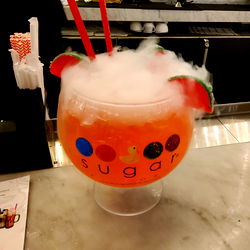 Frozen Drink with Smoke and Watermelon Garnish on Table