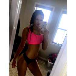 OnlyFans Model A Posing in Pink Sports Bra and Black Bikini Bottoms