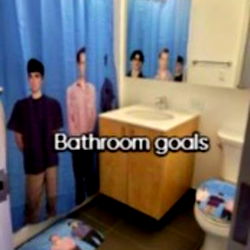 Bathroom with Blue Shower Curtain and Photo of Teenagers