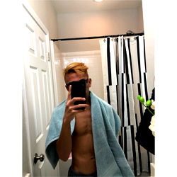 A Young Man Taking a Selfie in the Bathroom