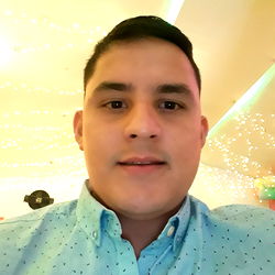 A young man, Andresgozu, smiles for the camera at a party