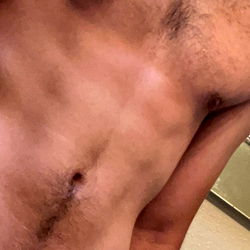 A Shirtless Model's Chest in a Mirror