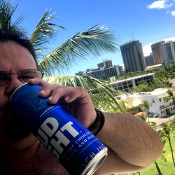 Man Enjoying a Beer on a Balcony