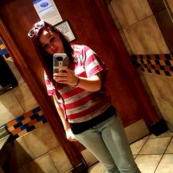 Casually Styled Woman in a Restaurant Bathroom