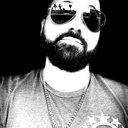 Sunglasses-clad man in beard and chain necklace, smiling from Cape Coral, FL