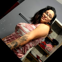 Cheyanna in a mirror selfie, showcasing her tattoos