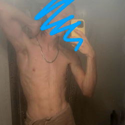 A gym-toned man takes a mirror selfie