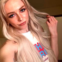 Long Blonde Haired Individual with Makeup and Sunglasses