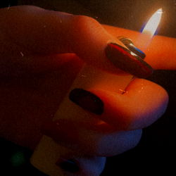 Candlelit Hand with Ring and Cigarette, Possibly Ms. Stoner