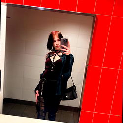 Stylish Ash from California posing in a bathroom mirror with phone and handbag, tagged as #OnlyFans model