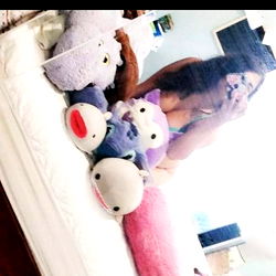 An OnlyFans Model Showcasing Her Collection of Stuffed Animals in the Bedroom