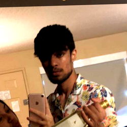 A Young Man Taking a Selfie with a Bottle of Spirits