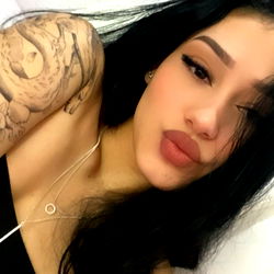 Ambercastle20, a stunning tattooed model poses for the camera