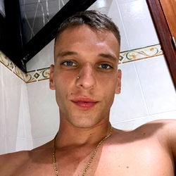 Young Adult Male with Tattoos, Shaved Hair and Jewelry