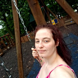 A Woman Swinging on a Playground