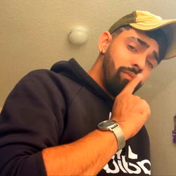 Puertorican Bush 🍆 from Tampa Bay, Florida: A Shirtless OnlyFans Model With a Smirk and Hand on Face